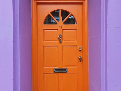 Local knowledge in Brighton & Hove property management, symbolised by a distinctive orange front door on a city home.