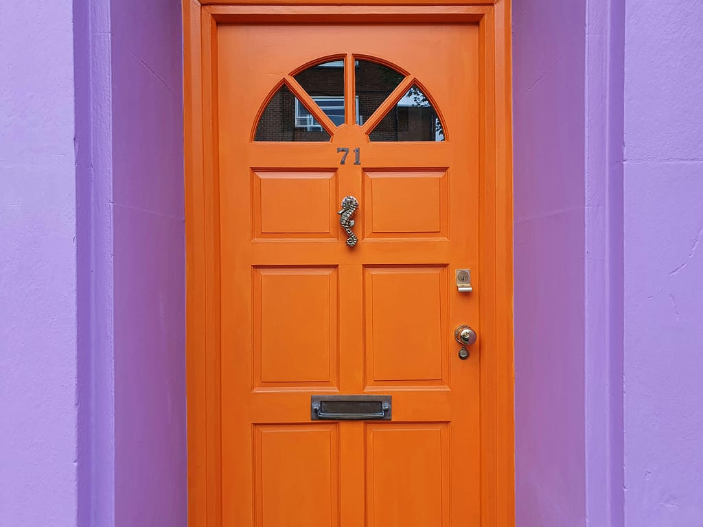 Local knowledge in Brighton & Hove property management, symbolised by a distinctive orange front door on a city home.